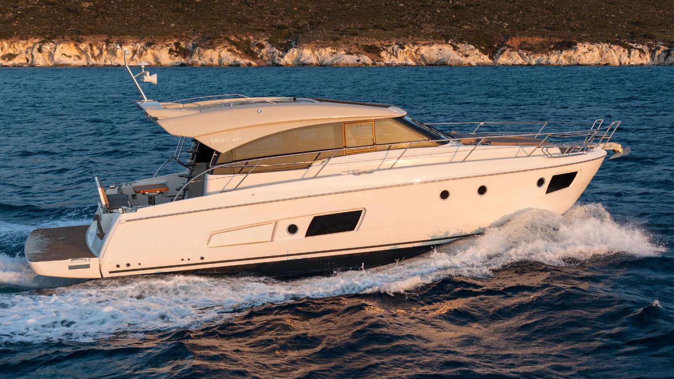 A white motor yacht cruising through the water of Massachusetts.